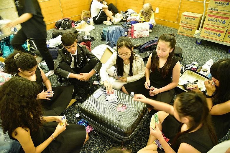 Some young performers play the card game Uno during a rehearsal break at the Singapore Press Holdings' News Centre auditorium. 