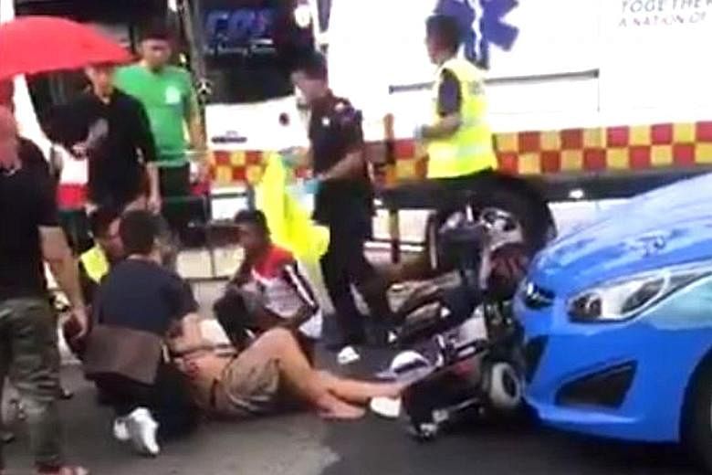 The rider of a personal mobility aid being tended to after a collision with a taxi in Choa Chu Kang last Saturday.