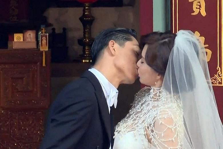The newly married couple sharing a kiss. Taiwanese model Chiling Lin and Japanese singer-actor Akira at their wedding ceremony in Tainan.