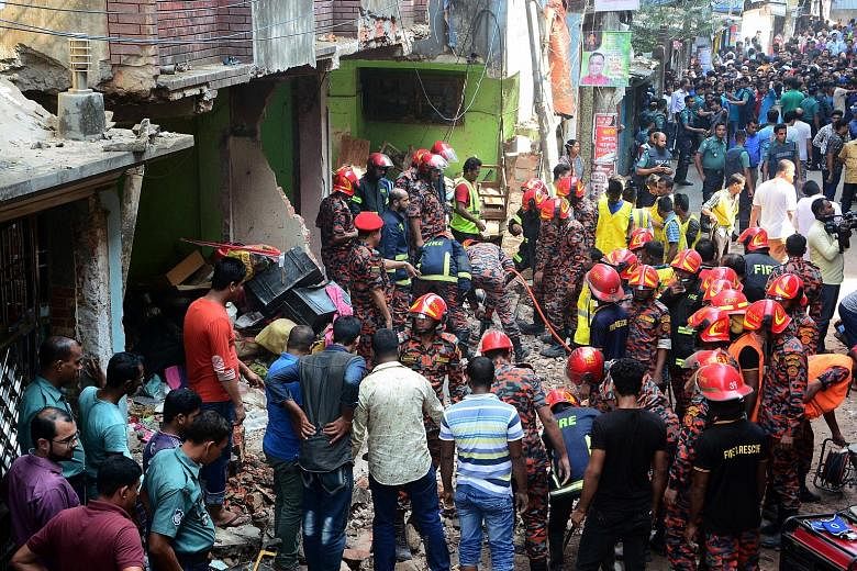 Rescue workers combing the site of a gas pipeline explosion in the Bangladesh port city of Chittagong yesterday. At least seven people were killed and eight injured in the blast, a police official said. The pipeline exploded in front of a five-storey