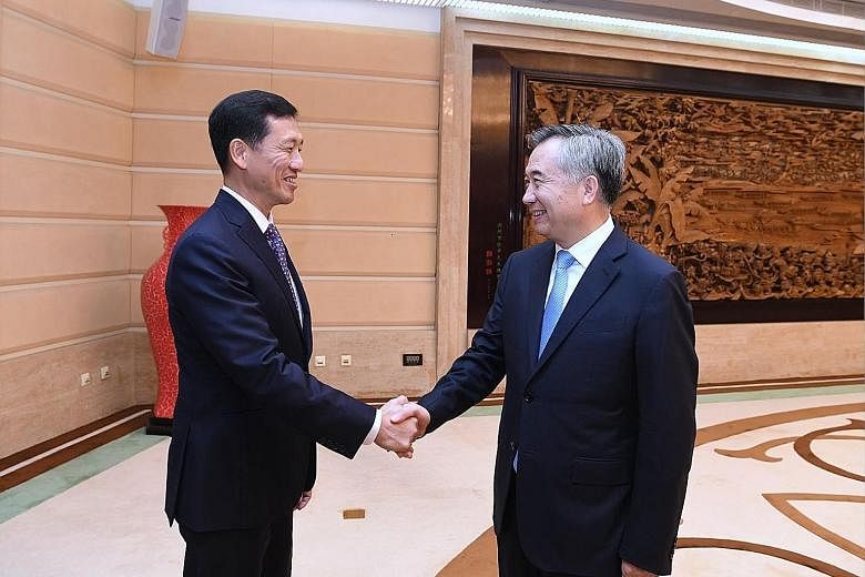 Education Minister Ong Ye Kung with Guangdong party boss Li Xi in Guangzhou yesterday. At an annual council meeting, Mr Ong spoke of how Singapore and Guangdong complement each other.