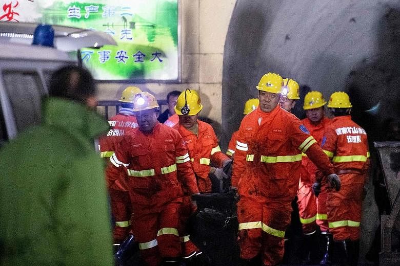 Rescuers carrying a victim out of the site of a coal mine explosion in Pingyao, in China's northern Shanxi province. A total of 35 miners were working underground when the blast happened.
