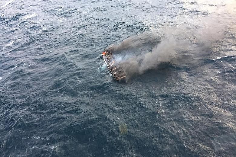 This photo taken yesterday and provided by the Korea Coast Guard shows a burning fishing boat in waters west of South Korea's southern island of Jeju. One fisherman was killed and 11 others reported missing after the boat caught fire, the local autho