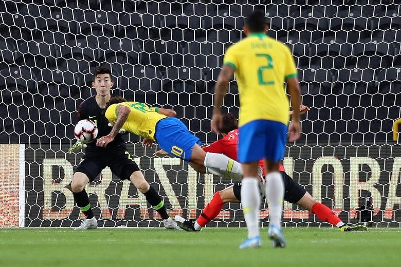 `Brazil's Lucas Paqueta stooping to head in the opening goal against South Korea, whose goalkeeper Jo Hyeon-woo could do little to prevent the goal. Brazil won 3-0 at the Mohammed bin Zayed Stadium in Abu Dhabi. PHOTO: REUTERS