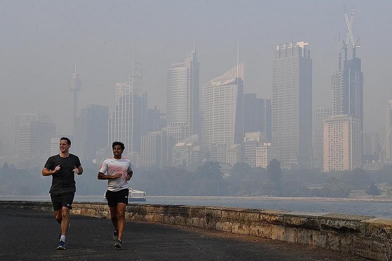The sky turning orange in Mildura in Victoria state, which registered record temperatures, with Melbourne hitting 40.9 deg C. Sydney's Harbour Bridge and central business district shrouded in haze yesterday. For the second time in three days, smoke f