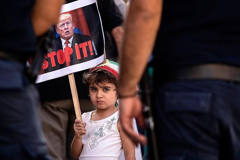 A girl in Cyprus with a placard of US President Donald Trump last month in a protest against the Turkish offensive into Syria. While some feel Mr Trump's departure would set the US and the world on a path back towards some idea of normal, the writer 