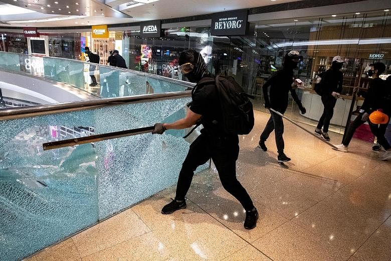 Protesters vandalising Festival Walk mall in Hong Kong on Nov 12. While Festival Walk is covered by insurance for damage and loss of income, uncertainty exists around the extent of coverage as well as the operating performance of the property after i