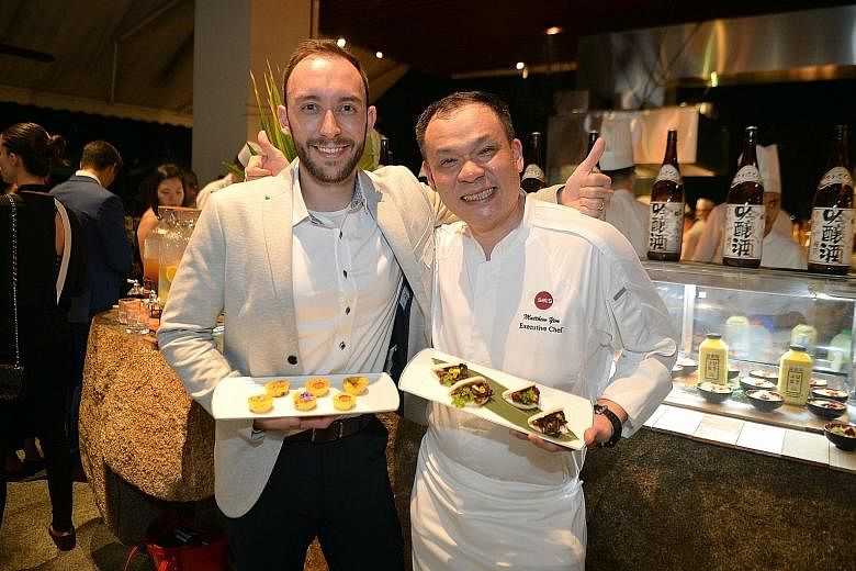 Country Foods general manager Andre Menezes with a plate of Just egg frittata and Sats' executive chef Matthew Yim with "char siew marinated Good Dot Proteiz on bun". The dishes were showcased on Thursday.