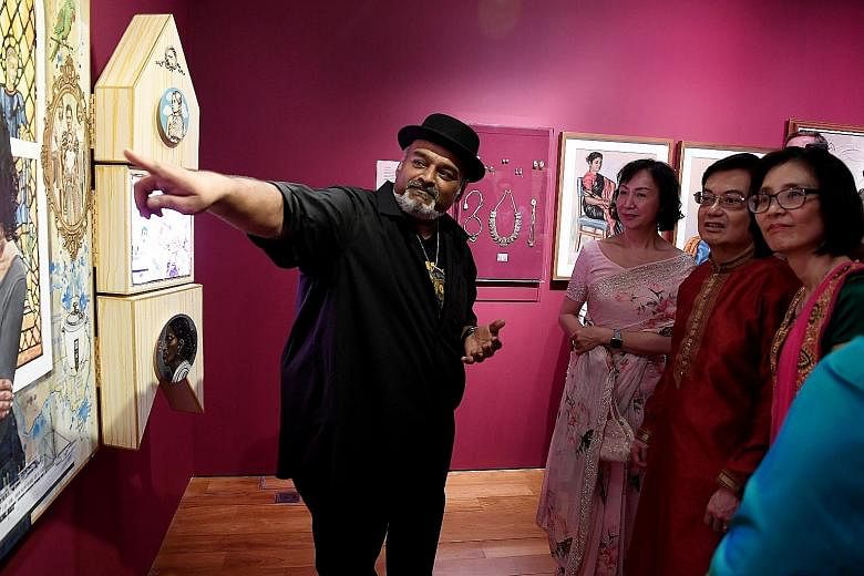 Artist Anurendra Jegadeva explaining his artwork, titled Heart In Hand, A Marriage of Identities, to Ms Yeoh Chee Yan (second from left), chairman of the National Heritage Board (NHB), Deputy Prime Minister Heng Swee Keat and NHB chief executive Chan