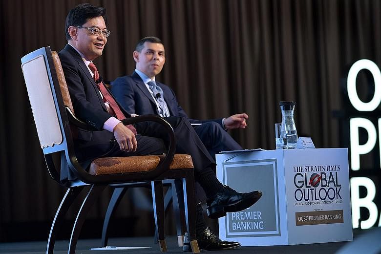 ST PHOTO: NG SOR LUAN Deputy Prime Minister Heng Swee Keat with Mr Warren Fernandez, editor-in-chief of Singapore Press Holdings' English/Malay/Tamil Media Group and editor of The Straits Times, at The Straits Times Global Outlook Forum yesterday. ST