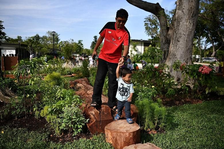 Mr Ahmad Abdillah and his 1½-year-old son Ahmad Khairi at the nature play garden yesterday. In order to provide natural shade and vibrancy, 800 trees have been planted at the new Cyclist Park.