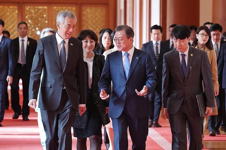 Prime Minister Lee Hsien Loong with South Korean President Moon Jae-in at Seoul's presidential Blue House yesterday, where the two leaders witnessed the signing and exchange of cooperation pacts in standards and conformance, manufacturing of pharmace