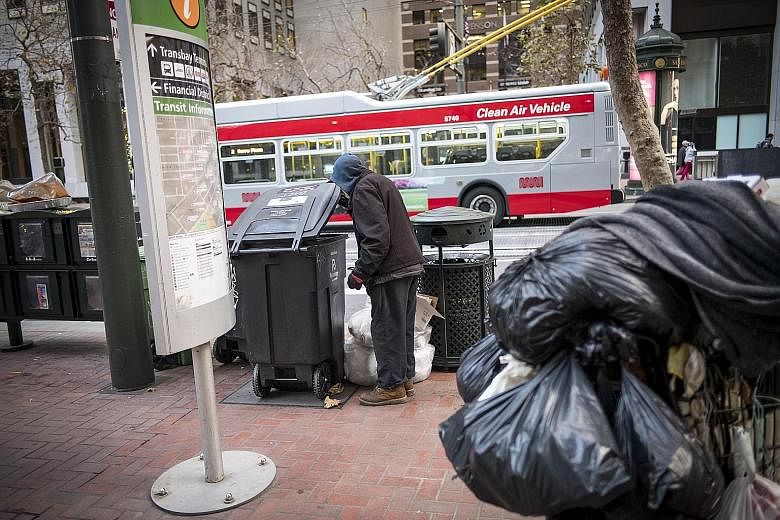 Trash receptacles on a San Francisco street. Waste, as a by-product of consumption, keeps piling up in the United States. As consumers have more money to buy more stuff, more gets thrown away.