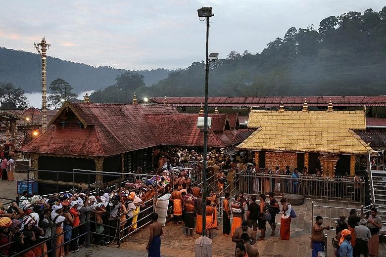 Hindu devotees at Sabarimala temple in Kerala in October last year. Following a Supreme Court verdict, women are now allowed to enter it, but the Kerala government has reverted to preventing women of childbearing age from doing so. PHOTO: REUTERS