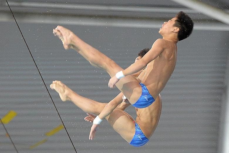 China's Duan Yu, 14 (front), and Wang Zewei, 16, on the way to winning the men's synchronised 10m platform at the Fina Diving Grand Prix at the OCBC Aquatic Centre yesterday. ST PHOTO: KELLY HU