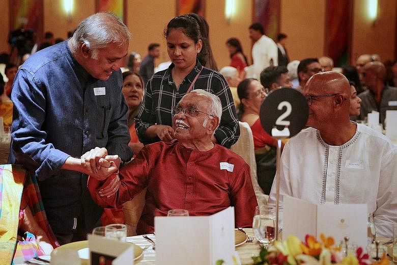 Mr Bala Subramanion, 102, Singapore's first Asian postmaster-general, being greeted by Mr M. Param (left), former vice-chairman of the Hindu Endowments Board, during last night's dinner at the Marina Mandarin hotel to mark the board's 50th anniversar
