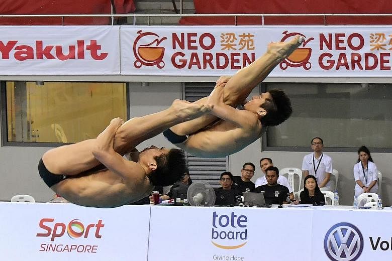 Singapore's Timothy (front) and Mark Lee showing good form on the final day of the Fina Diving Grand Prix Singapore at OCBC Aquatic Centre yesterday. They broke their synchronised 3m national record by more than five points to end fourth. 