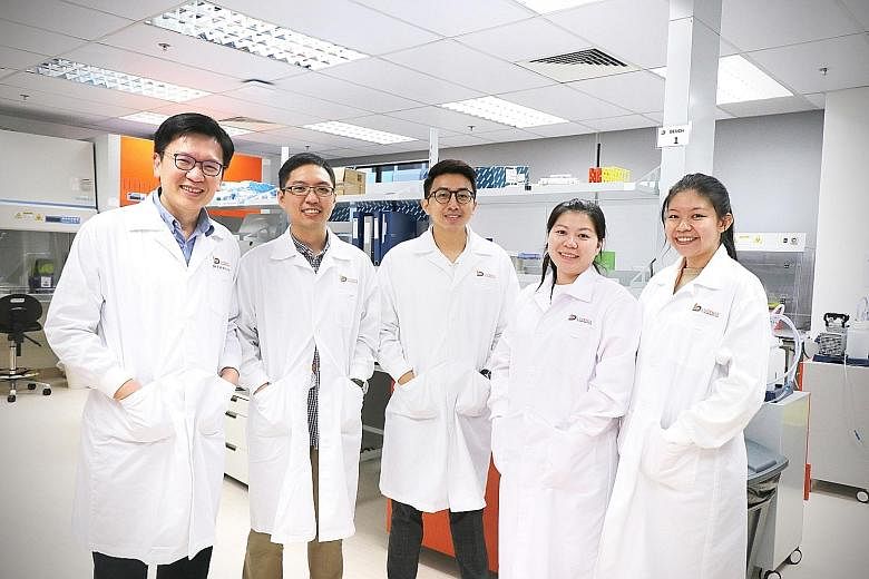 Dr Tan Min-Han (far left), founder and chief executive of Lucence, with members of the company's laboratory team in Singapore. He said Lucence conducts and processes the results of non-invasive tests on late-stage cancer patients using the company's 