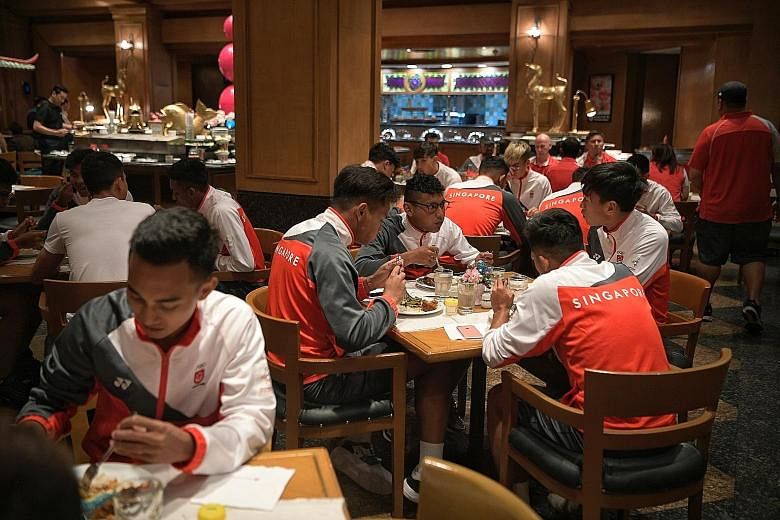 Above: The Singapore national football team having dinner with a wider variety of halal food yesterday at the Century Park Hotel's restaurant. Left: Last-minute renovation work being carried out yesterday at the Rizal Memorial Stadium, where football