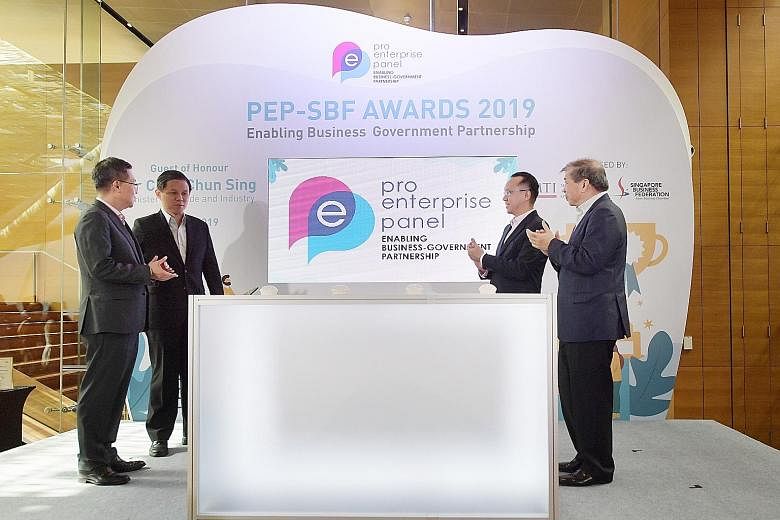 PEP chairman Leo Yip (from left), Minister for Trade and Industry Chan Chun Sing, Senior Parliamentary Secretary for Trade and Industry Tan Wu Meng and SBF chairman Teo Siong Seng launching the new PEP logo at the National Gallery Singapore.