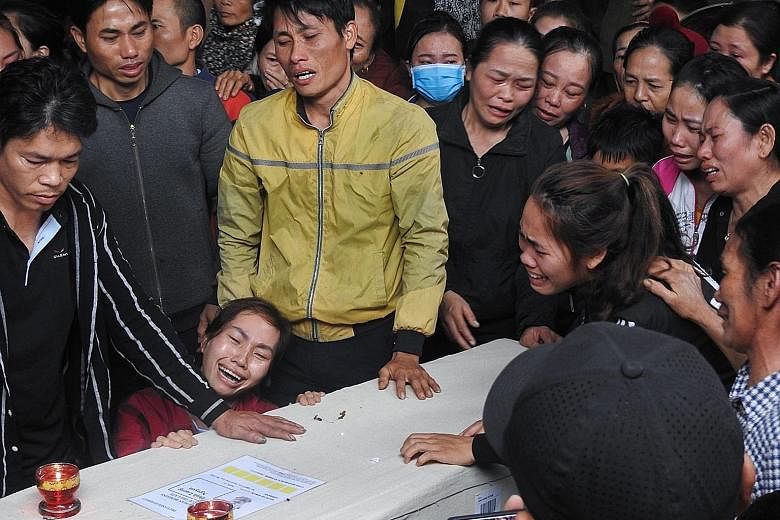 Relatives in Vietnam grieving over the repatriated remains of Mr Nguyen Dinh Luong, 20, who died in the back of a truck in Britain.