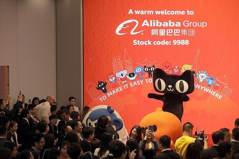 Alibaba's listing ceremony at the Hong Kong Stock Exchange on Tuesday, and Tencent's booth at the World 5G Exhibition in Beijing earlier this month. Hong Kong investors can now own shares in both Alibaba and Tencent after the e-commerce giant's local