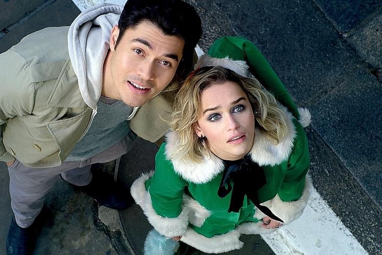 In Last Christmas, Emilia Clarke's character Kate, who hates her job working as an elf in a year-round Christmas shop, meets Tom (Henry Golding, both left) and is prodded into looking at the world differently.