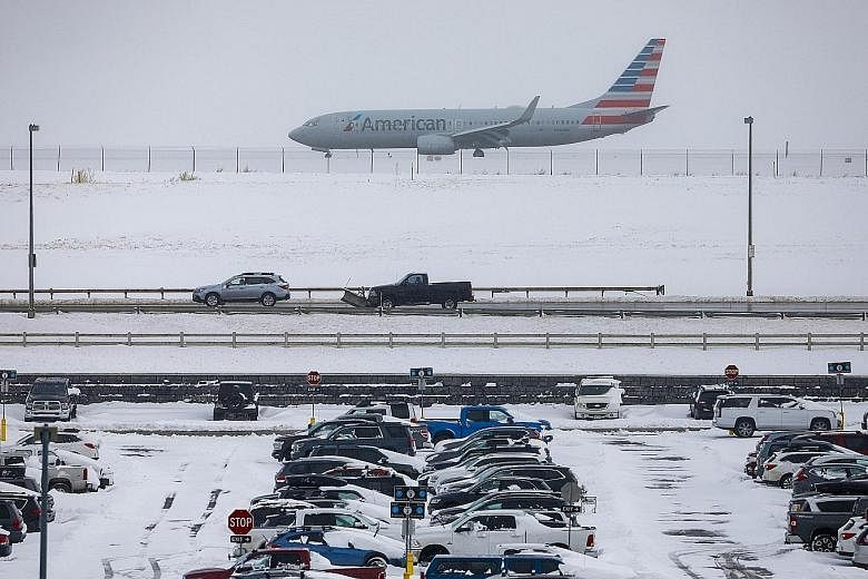Above: Denver International Airport's Twitter account reported more than 17cm of snow early on Tuesday morning. Although the airport was still operating, more than 475 flights through Denver had been cancelled. Below: Seventeen-year-old Jordan Dickma