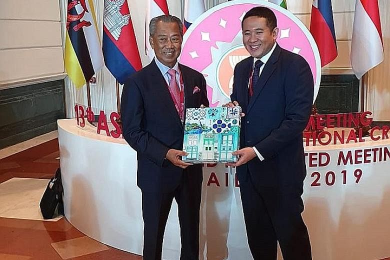 Senior Parliamentary Secretary for Health and Home Affairs Amrin Amin with Malaysia's Home Minister Muhyiddin Yassin (far left) during the 13th Asean Ministerial Meeting on Transnational Crime in Bangkok yesterday. PHOTO: MINISTRY OF HOME AFFAIRS
