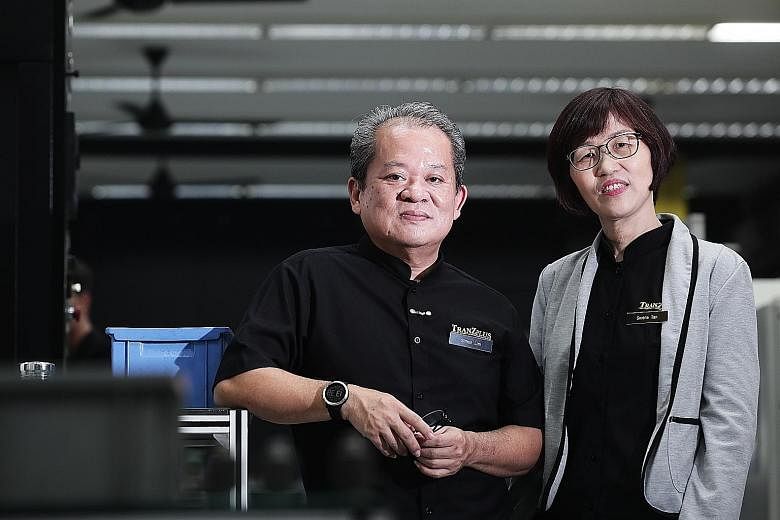 TranZplus general manager Simon Lim and finance manager Serene Tan. The senior employees went through professional conversion programmes to be equipped with skills for the manufacturing sector.