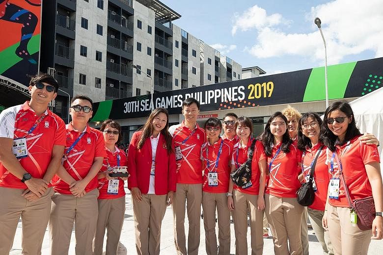 Team Singapore chef de mission Juliana Seow (fourth from left) with some athletes and officials during the welcome ceremony at the Games Village in the Philippines. 
