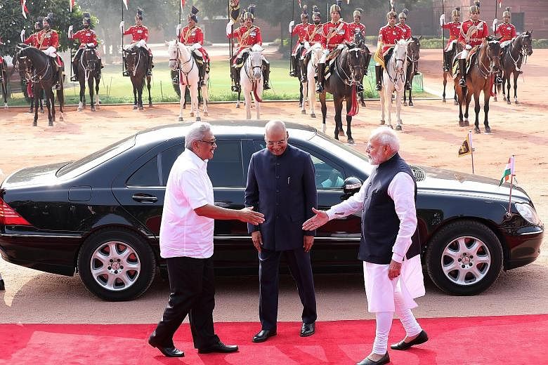(From left) Sri Lankan President Gotabaya Rajapaksa is welcomed by Indian President Ram Nath Kovind and Indian Prime Minister Narendra Modi at Rashtrapati Bhavan, India's presidential palace in New Delhi, yesterday. PHOTO: EPA-EFE
