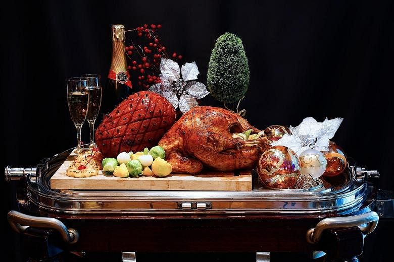 Chocolate truffle log cake, honey-baked ham and Christmas turkey are among the items diners can feast on at the Festive Seafood Extravaganza Buffet at Cafe 2000. PHOTOS: M HOTEL SINGAPORE