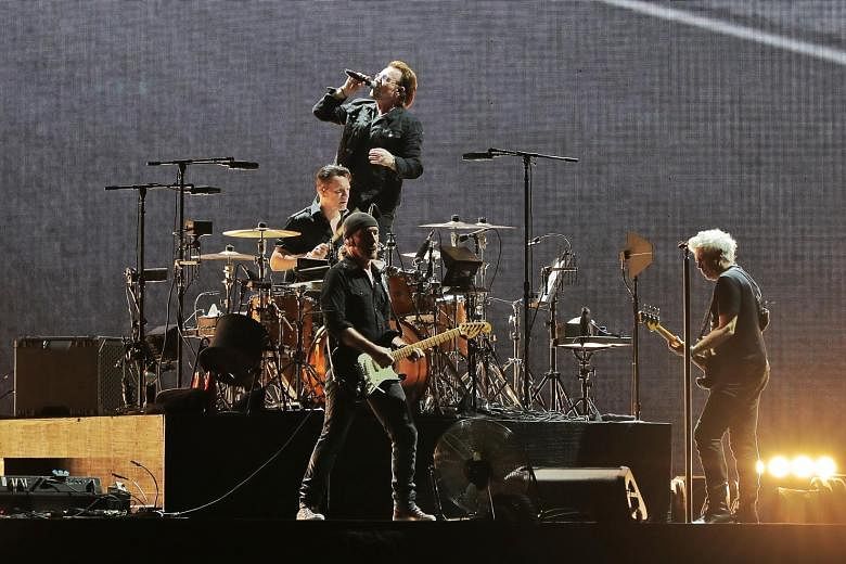 Irish rock band U2 comprising (from left) drummer Larry Mullen, guitarist The Edge, frontman Bono and bassist Adam Clayton performing at the National Stadium to a 50,000-strong sold-out crowd yesterday.