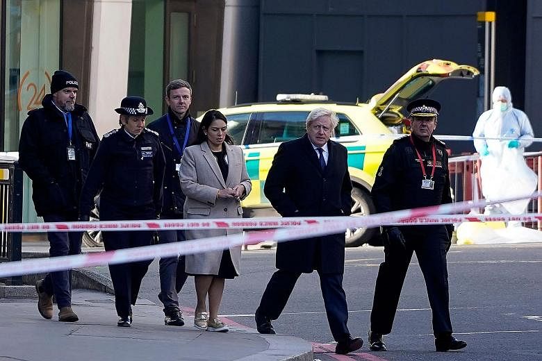 British Prime Minister Boris Johnson, flanked by Home Secretary Priti Patel and City of London Police Commissioner Ian Dyson, arriving yesterday at the scene of the attack on London Bridge. Mr Johnson cancelled his election activities yesterday so he