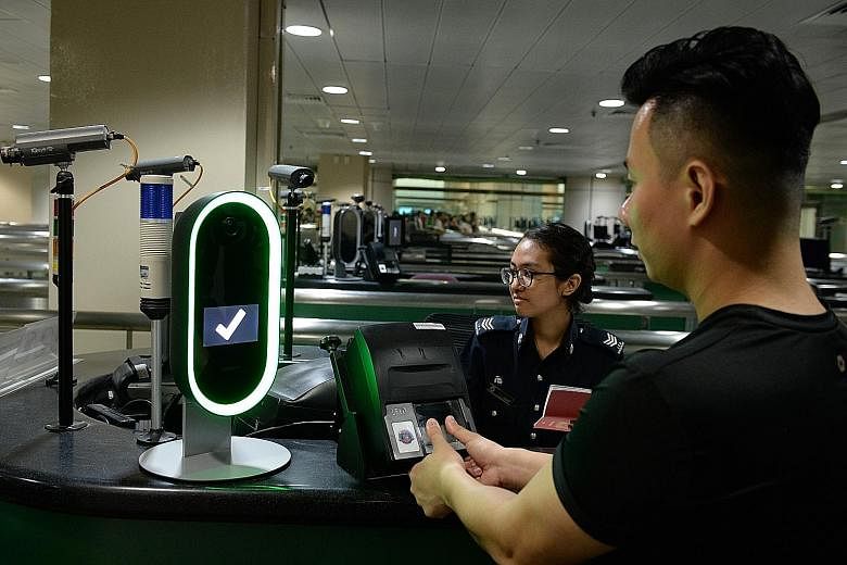 A demonstration of a biometric screening system with three modes of identification - fingerprint, facial and iris scans - at Woodlands Checkpoint. LIANHE ZAOBAO FILE PHOTO