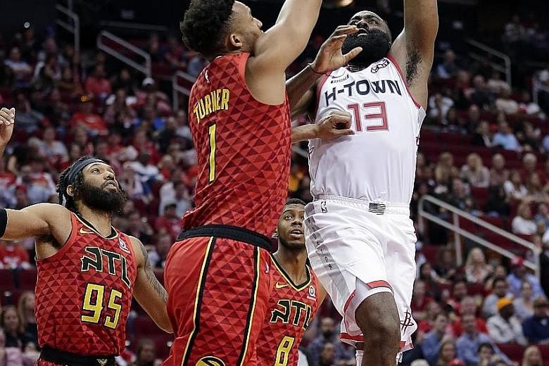 Houston's James Harden shooting over Atlanta guard Evan Turner on Saturday, when he came within one point of his career high.