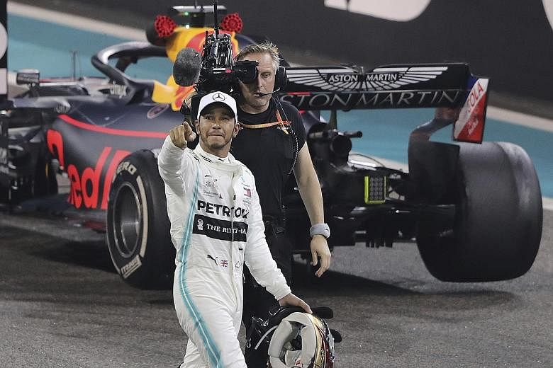 Mercedes driver Lewis Hamilton saluting the crowd after winning the Formula One Grand Prix in Abu Dhabi yesterday, dedicating his victory to the fans. 