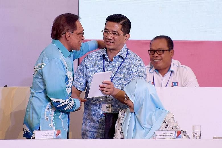 In this file photo taken last year, Parti Keadilan Rakyat chief Anwar Ibrahim (left) is seen congratulating PKR deputy president Azmin Ali after the latter gave a speech at the 13th PKR National Congress 2018.