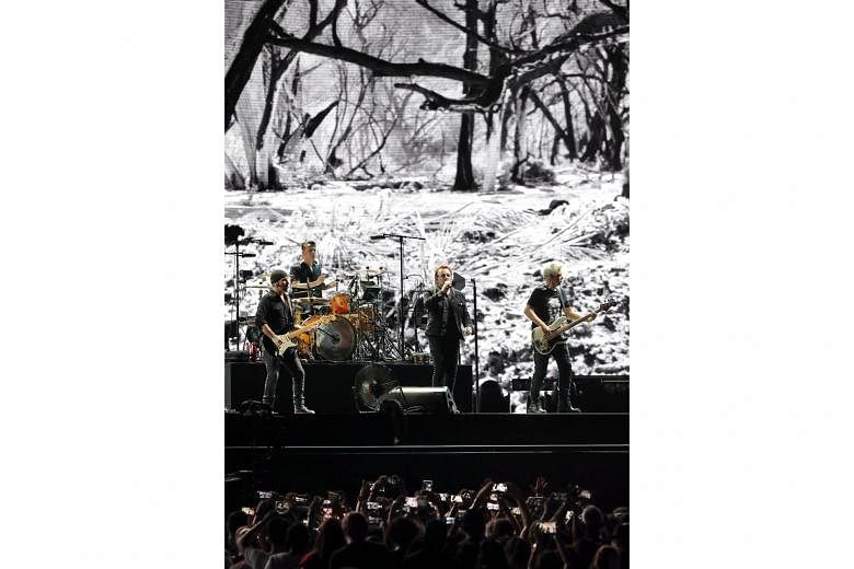 Cinematic visuals by Dutch photographer Anton Corbijn on the giant screen at U2’s concert are evocative and enhance the magnitude of the songs.