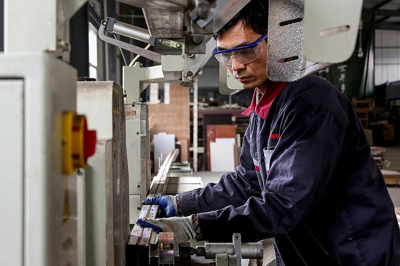 An employee working on aluminium products at a factory in Shandong province last month. Though Chinese factory activity has picked up, economists say much depends on how the ongoing US-China trade talks play out and how sustained the upswing in China