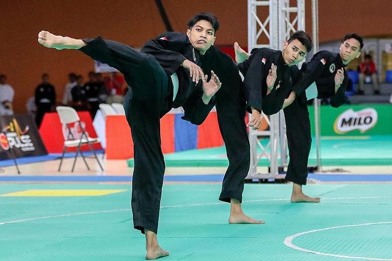 From far left: Nazrul Kamal, Nujaid Hasif, Hamillatu Arash won the men's seni regu team gold, Singapore's first in the artistic event. The trio were champions for the first time yesterday, at the Subic Bay Exhibition and Convention Centre in Manila, 
