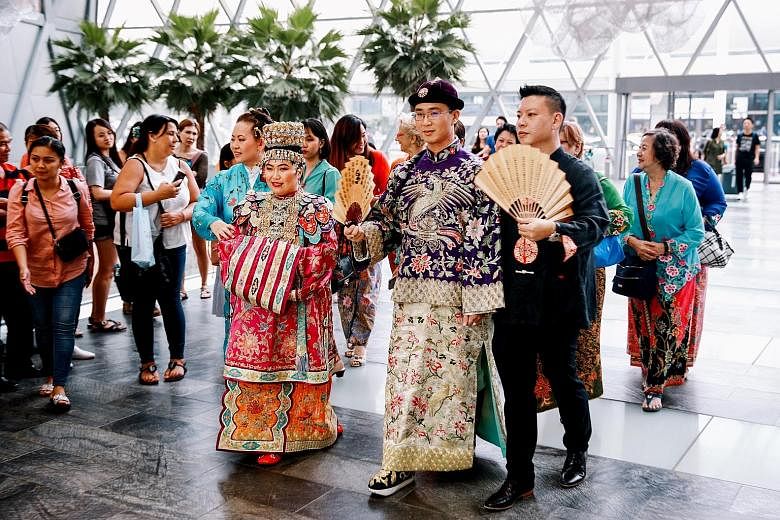 The couple, software programmer Huang Wen, 26, and engineer Laurie Huang, 27, wore traditional Peranakan wedding outfits for the ceremony, and were covered in the family's jewellery. Mr Huang was born in the United States, but both his parents are of