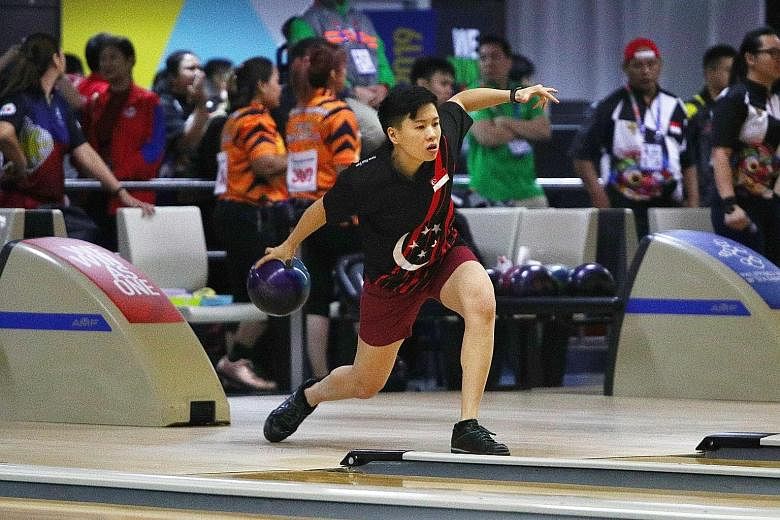 Singapore bowler New Hui Fen pulled away in the fifth game - winning it 235-176 - of the see-saw battle with silver medallist Tannya Roumimper. PHOTO: LIANHE ZAOBAO