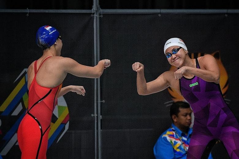Amanda Lim (left) and Quah Ting Wen sharing a personalised fist bump at the 2017 SEA Games, where the team clinched their best away haul of 19 golds.