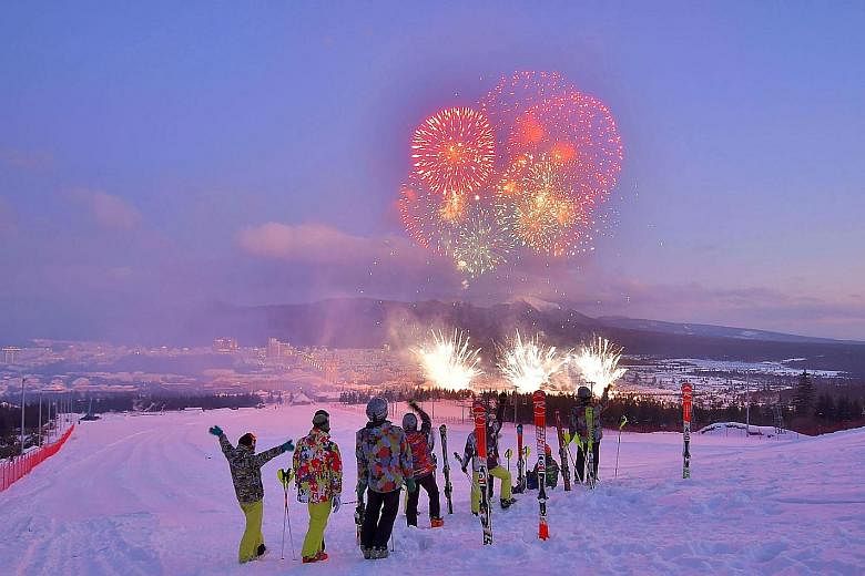 Skiers watching fireworks during a ceremony to mark the completion of the township of Samjiyon county in North Korea on Monday. The city is envisaged as a "socialist utopia" with new apartments, hotels, a ski resort and commercial, cultural and medic