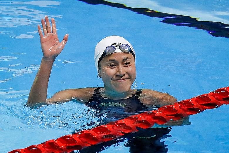 Top: The youngest of the Quah siblings, Jing Wen, started the gold rush in the pool by retaining her 200m butterfly title in the first final. Above: Ting Wen, the eldest, set a 100m freestyle SEA Games record of 54.74sec, taking 0.01 off the time she