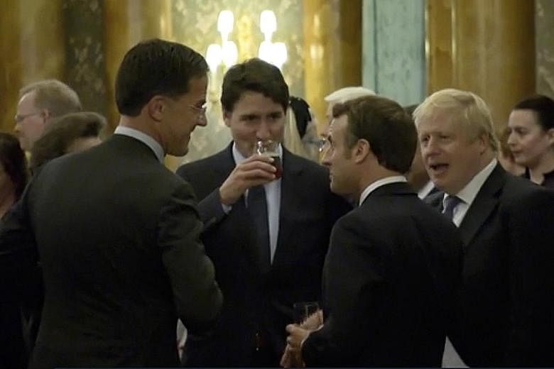 This video screengrab from a reception for Nato leaders at Buckingham Palace on Tuesday shows (from left) Dutch Prime Minister Mark Rutte, Canadian Prime Minister Justin Trudeau, French President Emmanuel Macron and British Prime Minister Boris Johns