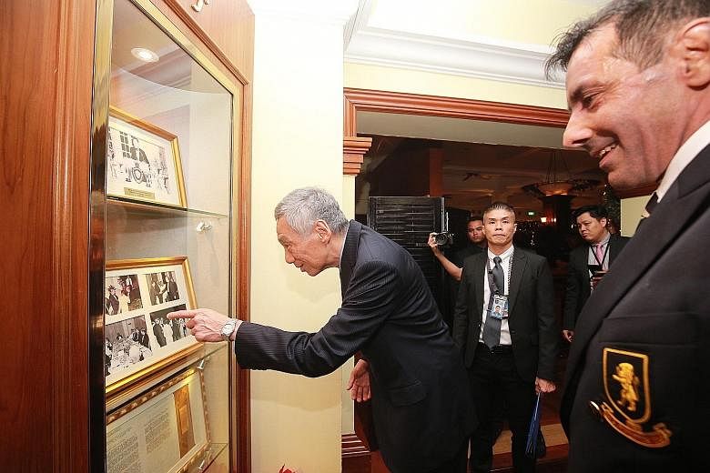 Prime Minister Lee Hsien Loong looking at photographs displayed at the Singapore Cricket Club which feature the late Mr Lee Kuan Yew. PM Lee was conferred the club's honorary title of Distinguished Visitor yesterday.