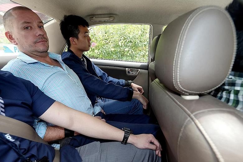 Andrew Gosling being taken to court in August. Yesterday, he was charged with one count of causing hurt with an instrument, with the new offence described in court documents as being "religiously aggravated". ST PHOTO: WONG KWAI CHOW